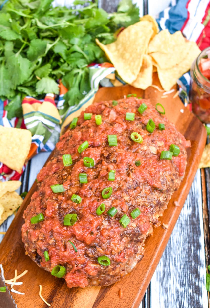 a mexican meatloaf on a wooden cutting board