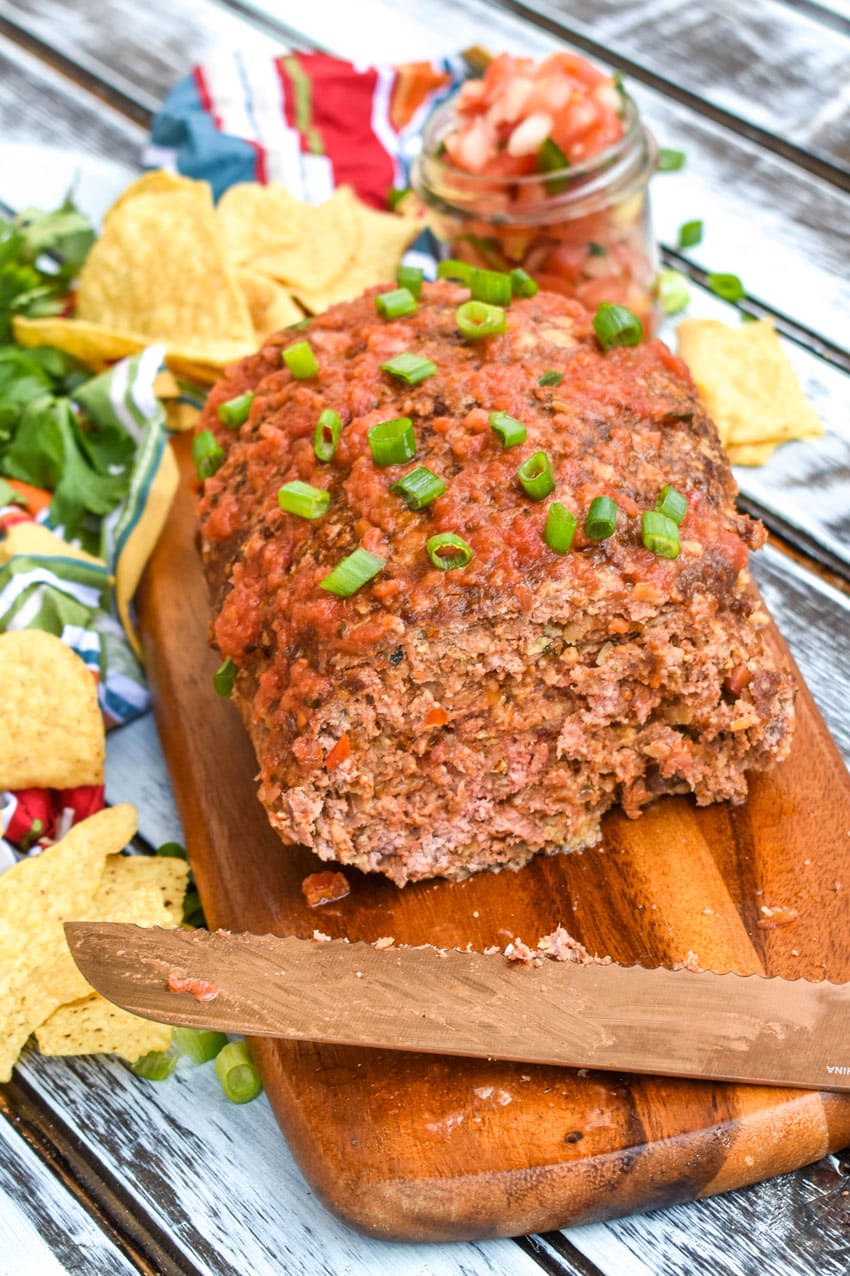 a mexican meatloaf on a wooden cutting board