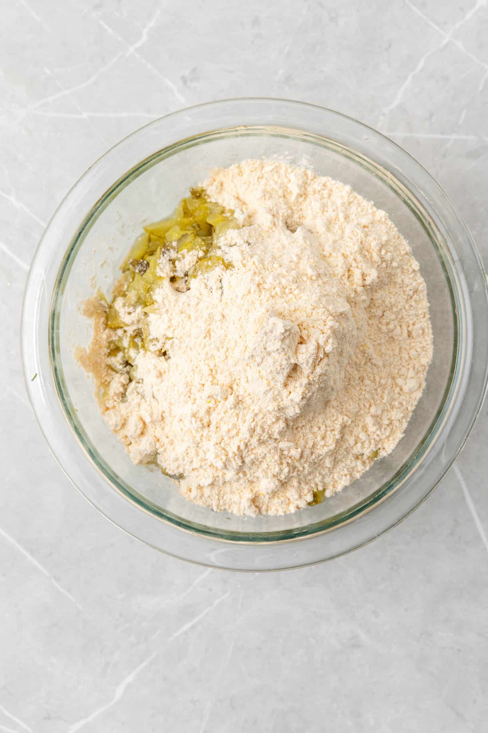 dill pickle fritter batter dry ingredients in a glass mixing bowl