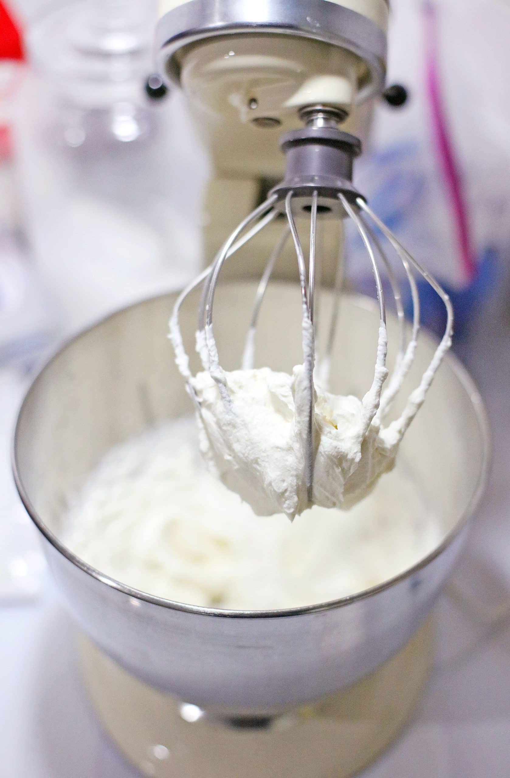 cheesecake filling in the bowl of a stainless steel stand mixer