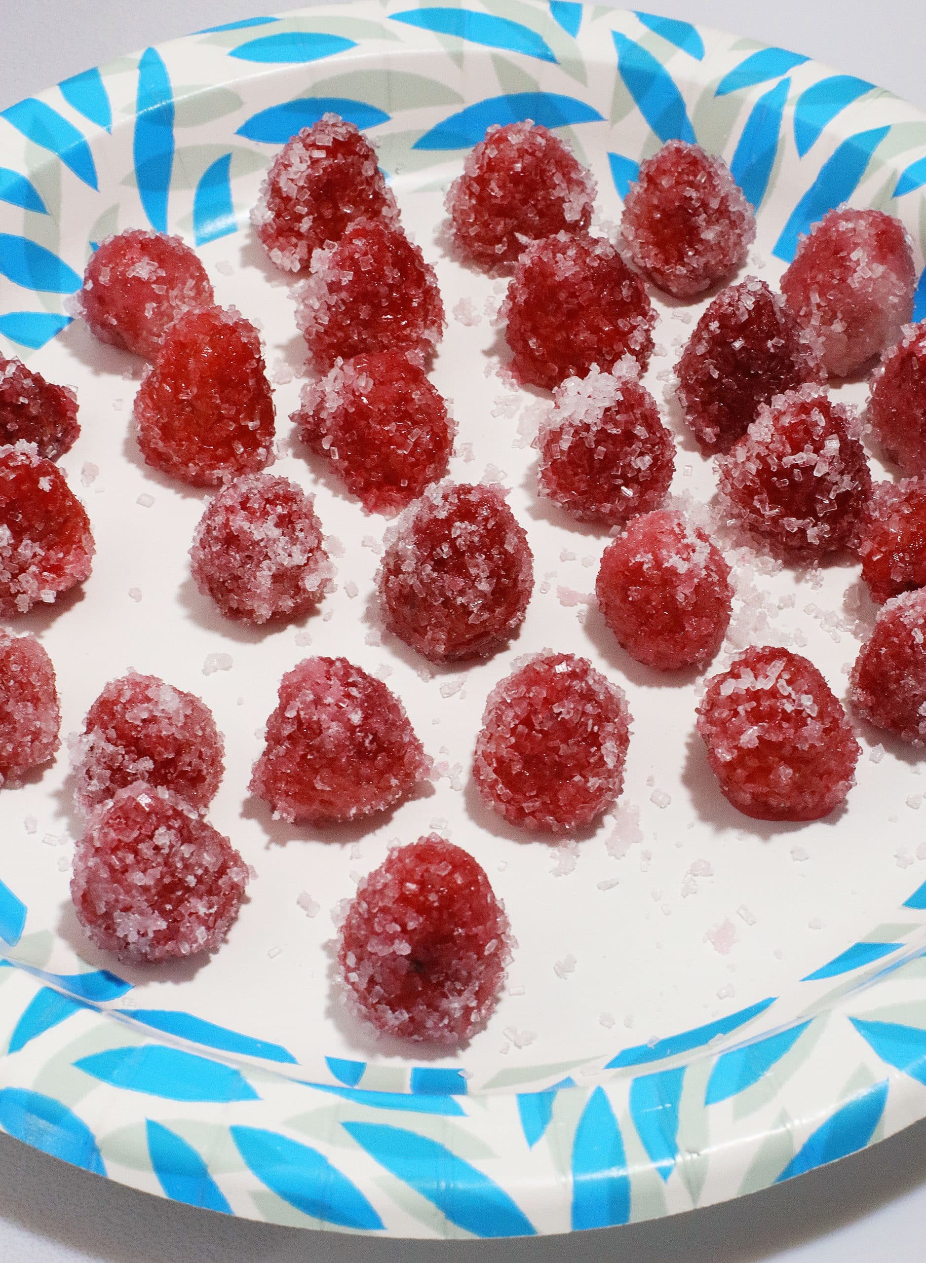 sugar coated raspberries on a paper plate