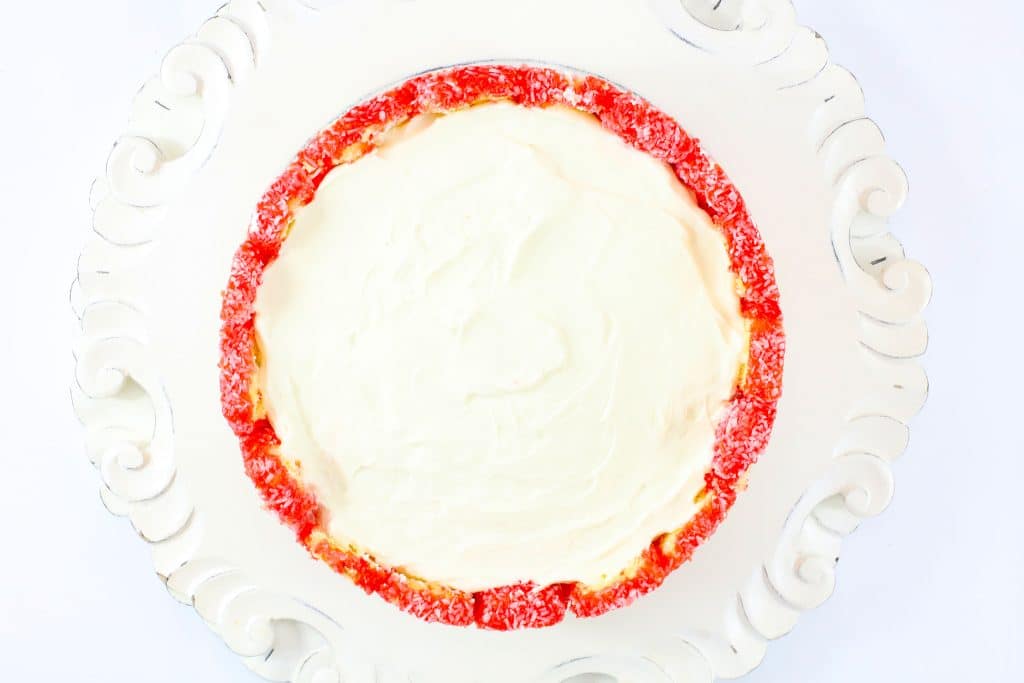 raspberry zinger cheesecake on a white cake plate