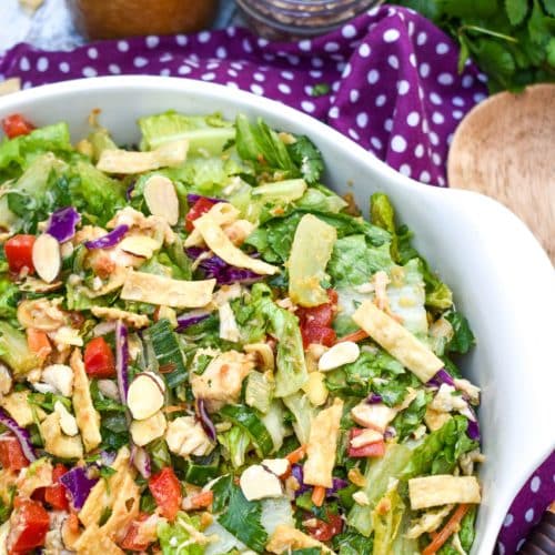 an asian chopped salad in a white serving bowl