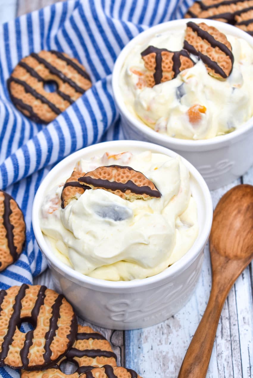 cookie salad in two small white bowls with pieces of fudge strip cookies on top as garnish
