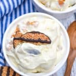 cookie salad in two small white bowls with pieces of fudge strip cookies on top as garnish