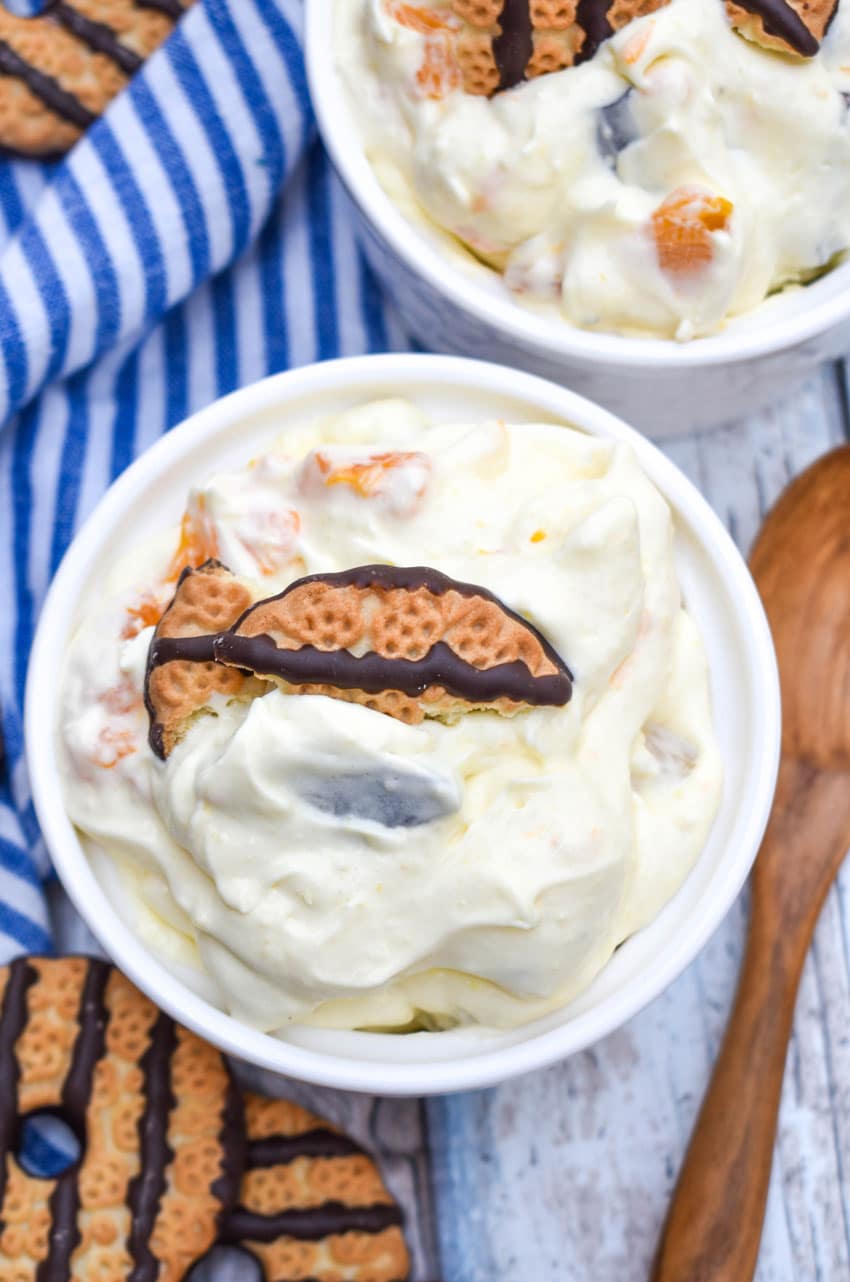 cookie salad in two small white bowls with pieces of fudge strip cookies on top as garnish