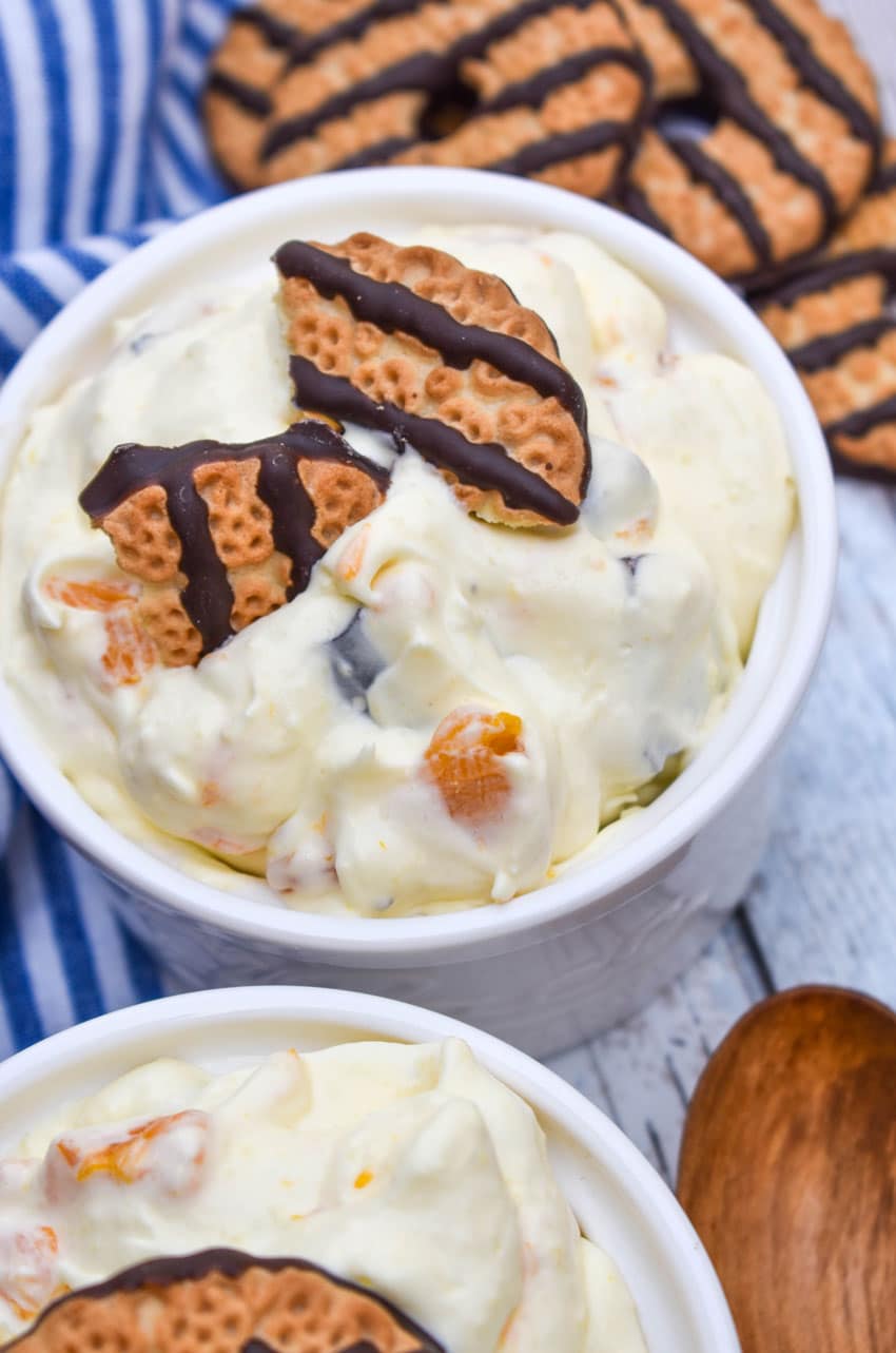 cookie salad in two small white bowls with pieces of fudge strip cookies on top as garnish
