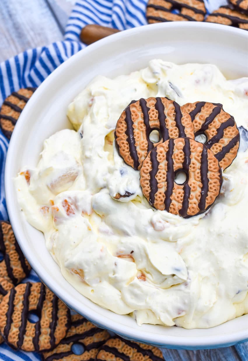 cookie salad in a large white serving bowl topped with three fudge strip cookies for garnish