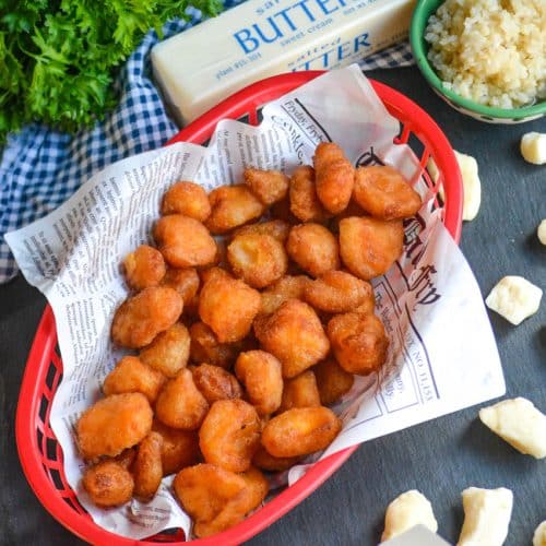 fried cheese curds in a paper lined plastic food basket