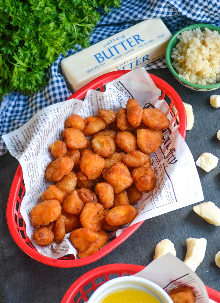 Fried Cheese Curds fried cheese curds in a paper lined plastic food basket