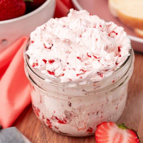homemade strawberry butter recipe in a small glass jar on a wooden cutting board
