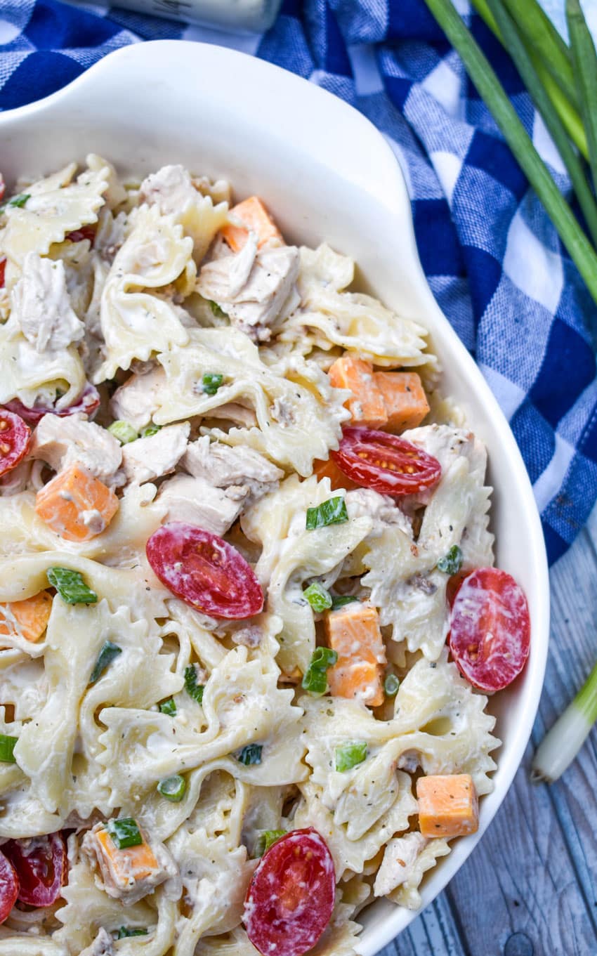 chicken bacon ranch pasta salad in a large white serving bowl