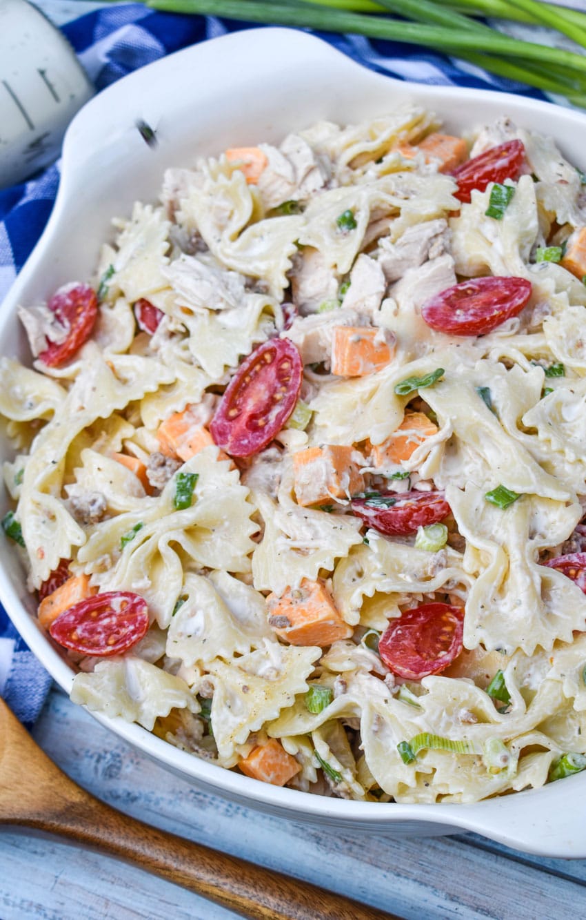 chicken bacon ranch pasta salad in a large white serving bowl