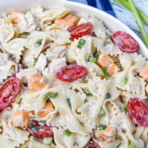 chicken bacon ranch pasta salad in a large white serving bowl