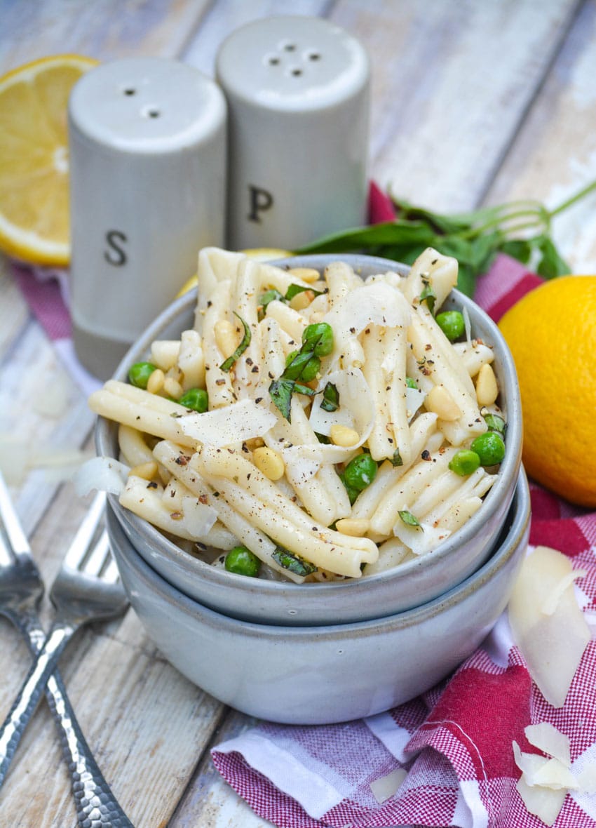 lemon basil pasta salad in a small gray bowl stacked on top of another small gray bowl