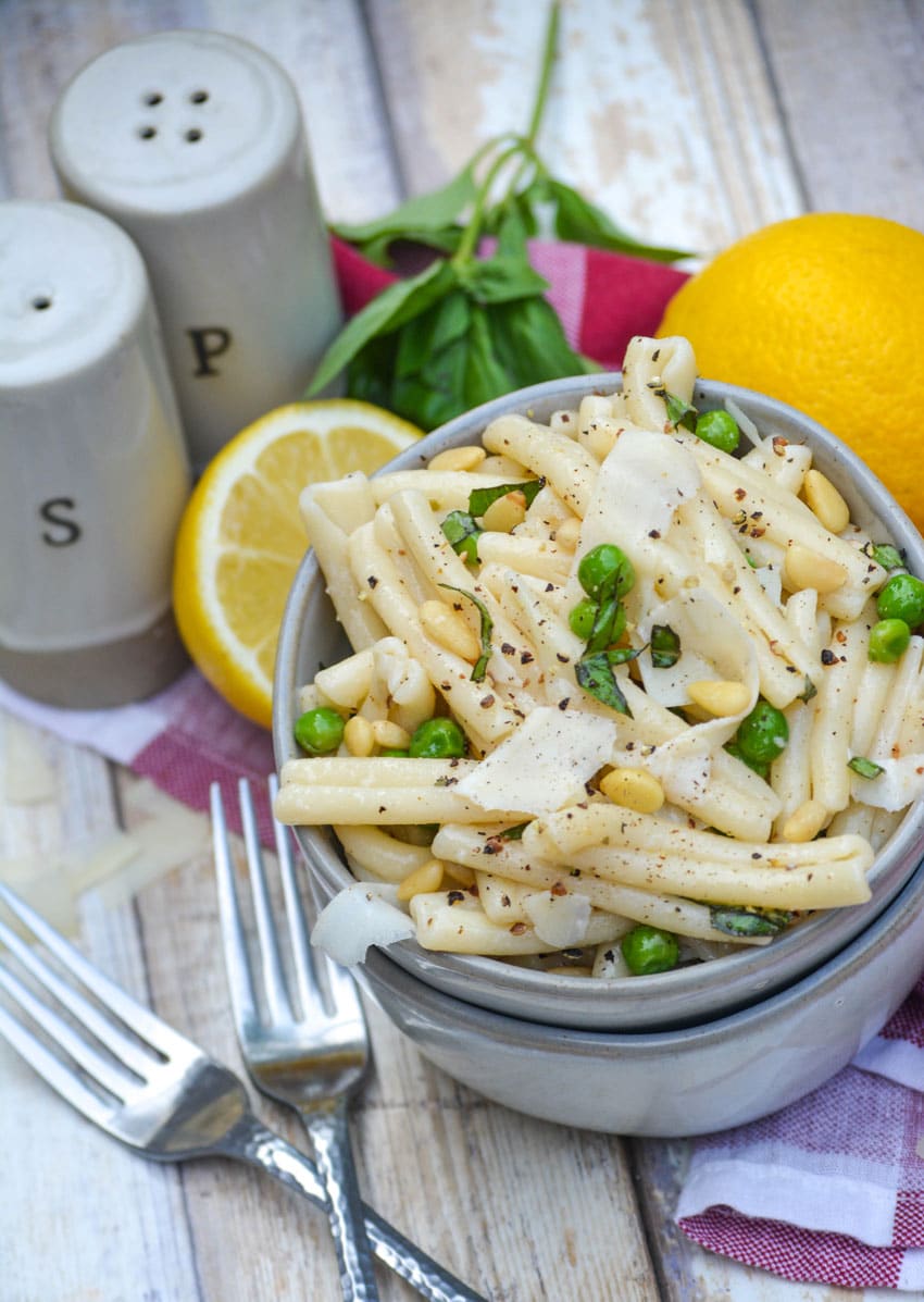 lemon basil pasta salad in a small gray bowl stacked on top of another small gray bowl