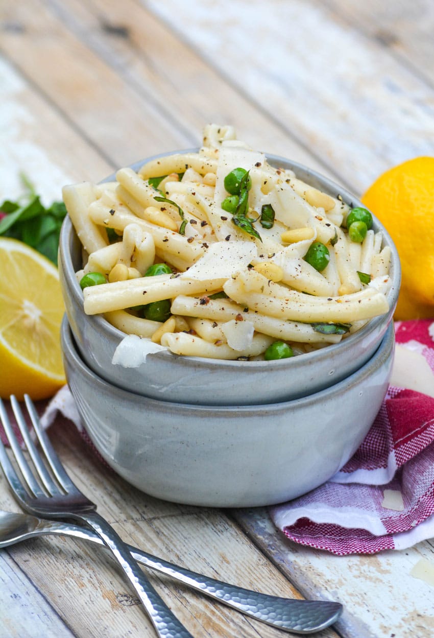 lemon basil pasta salad in a small gray bowl stacked on top of another small gray bowl