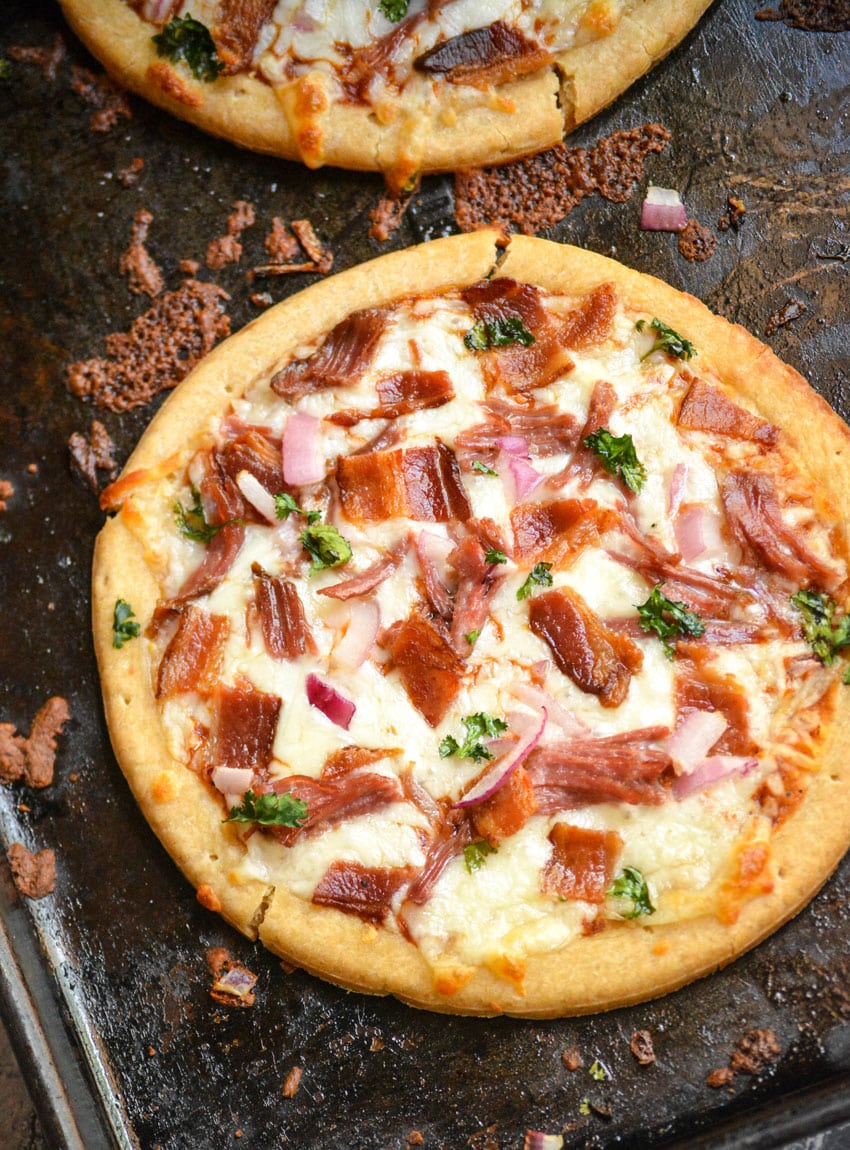 an american pulled pork pizza on a metal baking sheet