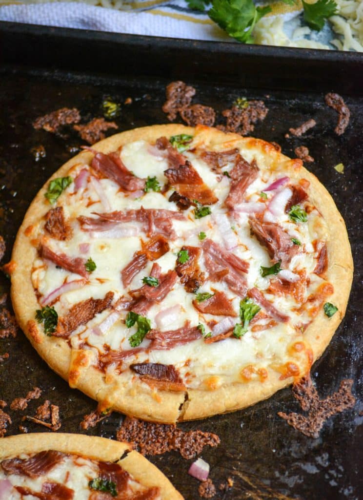 an american pulled pork pizza on a metal baking sheet