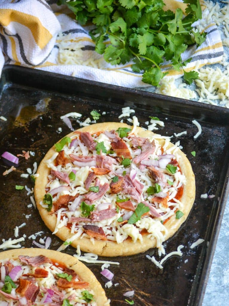 an uncooked barbecue pulled porlkpizza