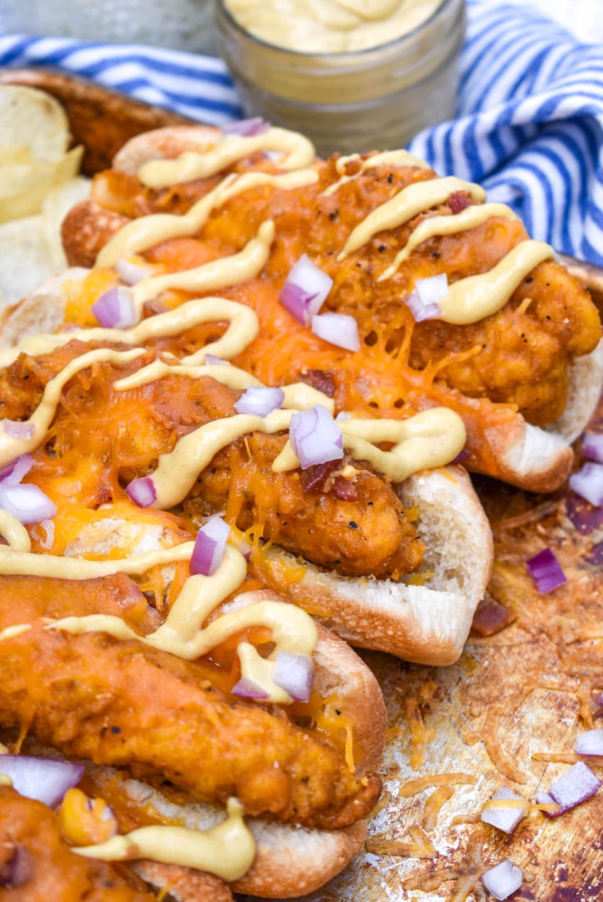 southern bird dog sandwiches arranged in a row on a metal sheet pan