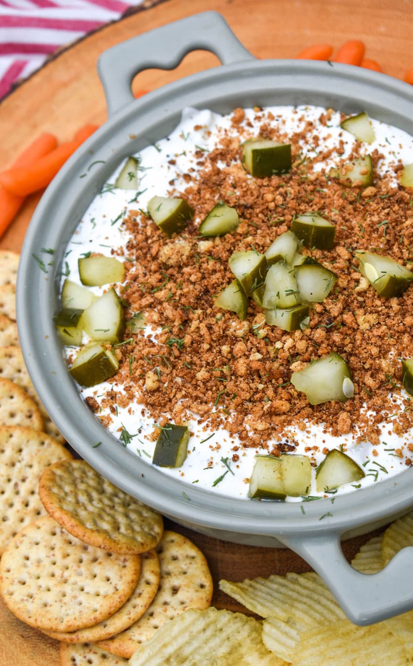 southern fried pickle dip in a gray serving bowl surrounded by assorted crackers