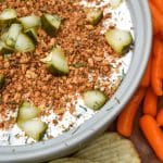 southern fried pickle dip in a gray serving bowl surrounded by assorted crackers