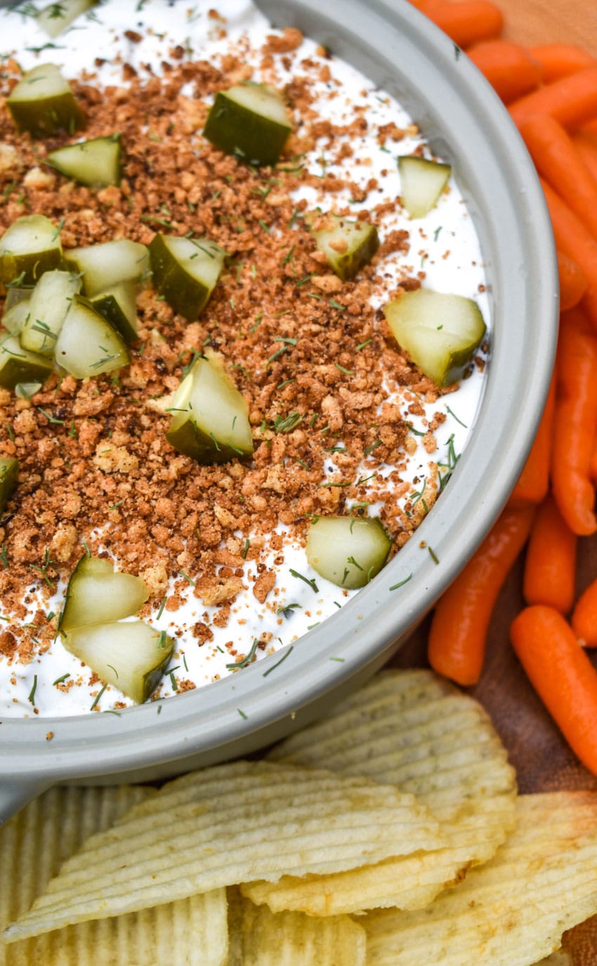 southern fried pickle dip in a gray serving bowl surrounded by assorted crackers