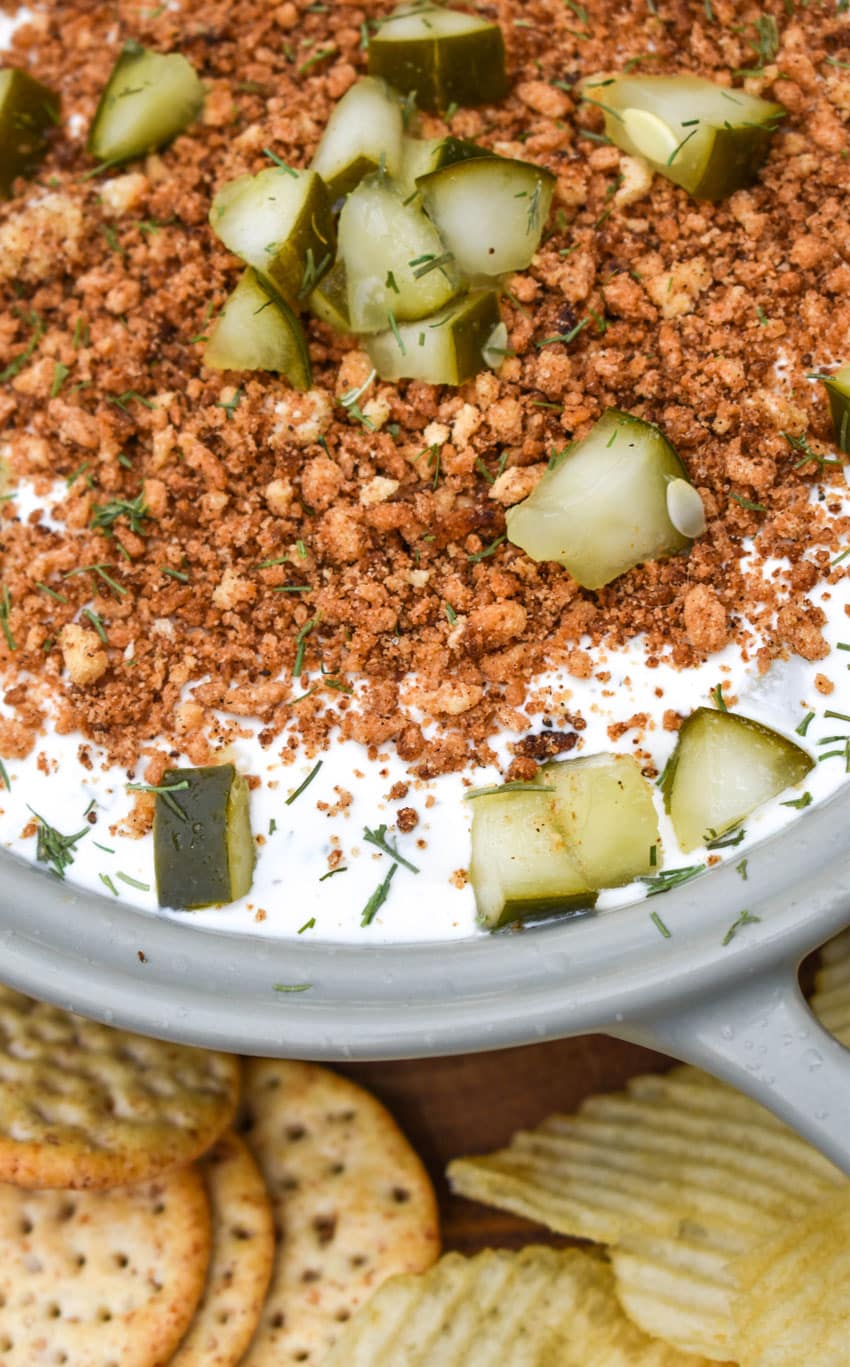 southern fried pickle dip in a gray serving bowl surrounded by assorted crackers