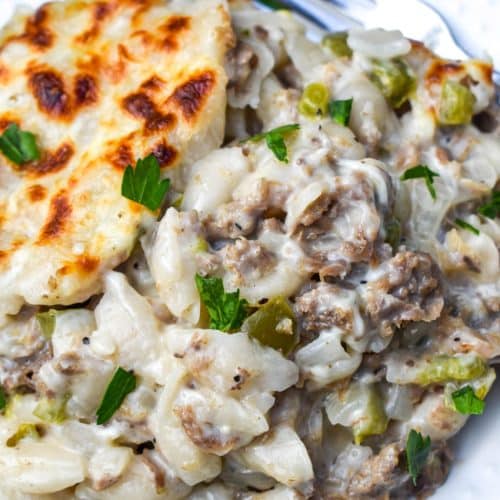 philly cheesesteak mac and cheese on a white plate