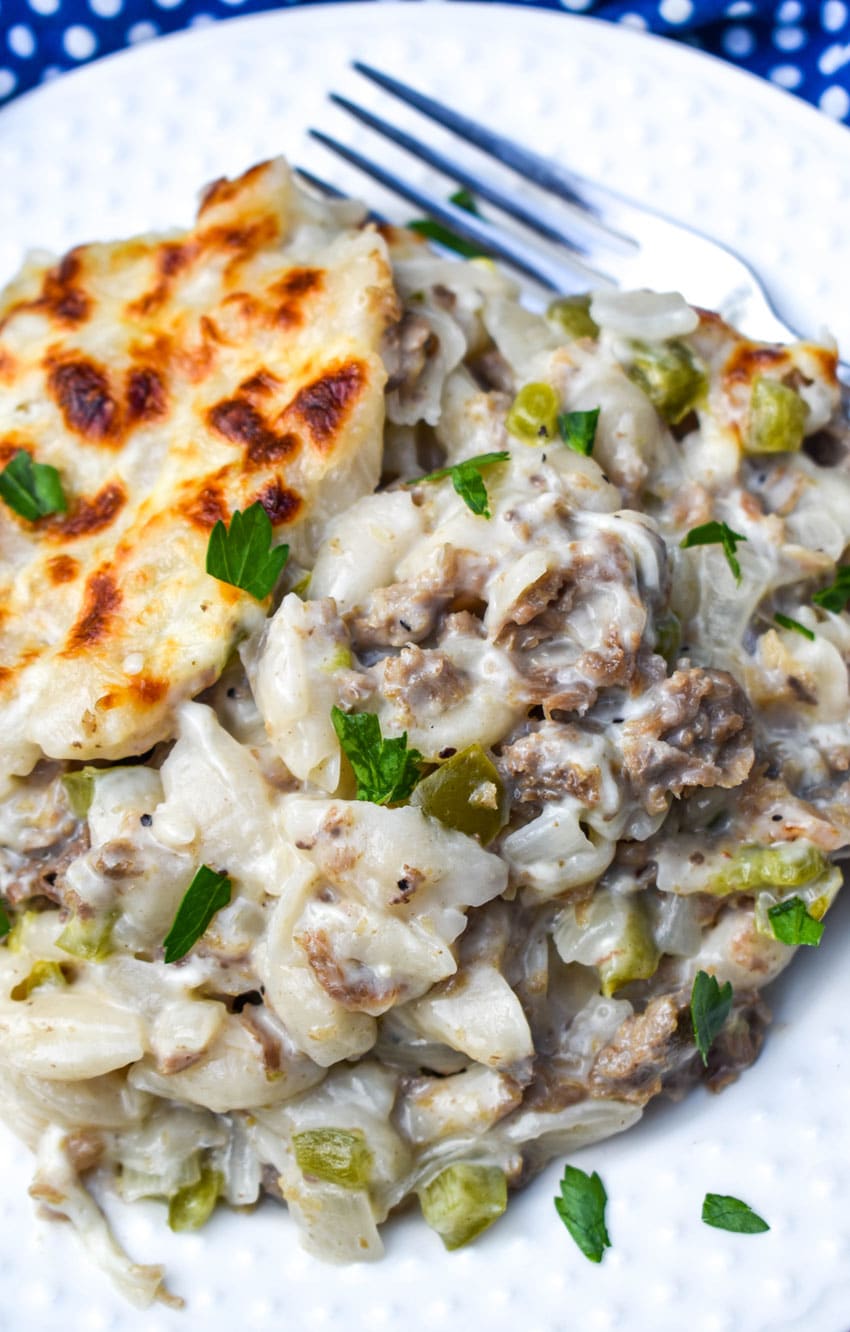 Philly Cheesesteak Mac & Cheese (From A Box) philly cheesesteak mac and cheese on a white plate