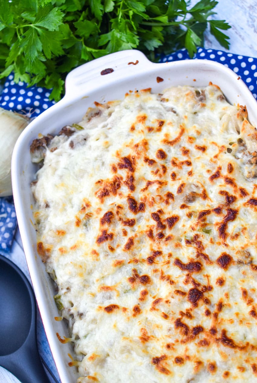 philly cheesesteak mac and cheese in a white baking dish