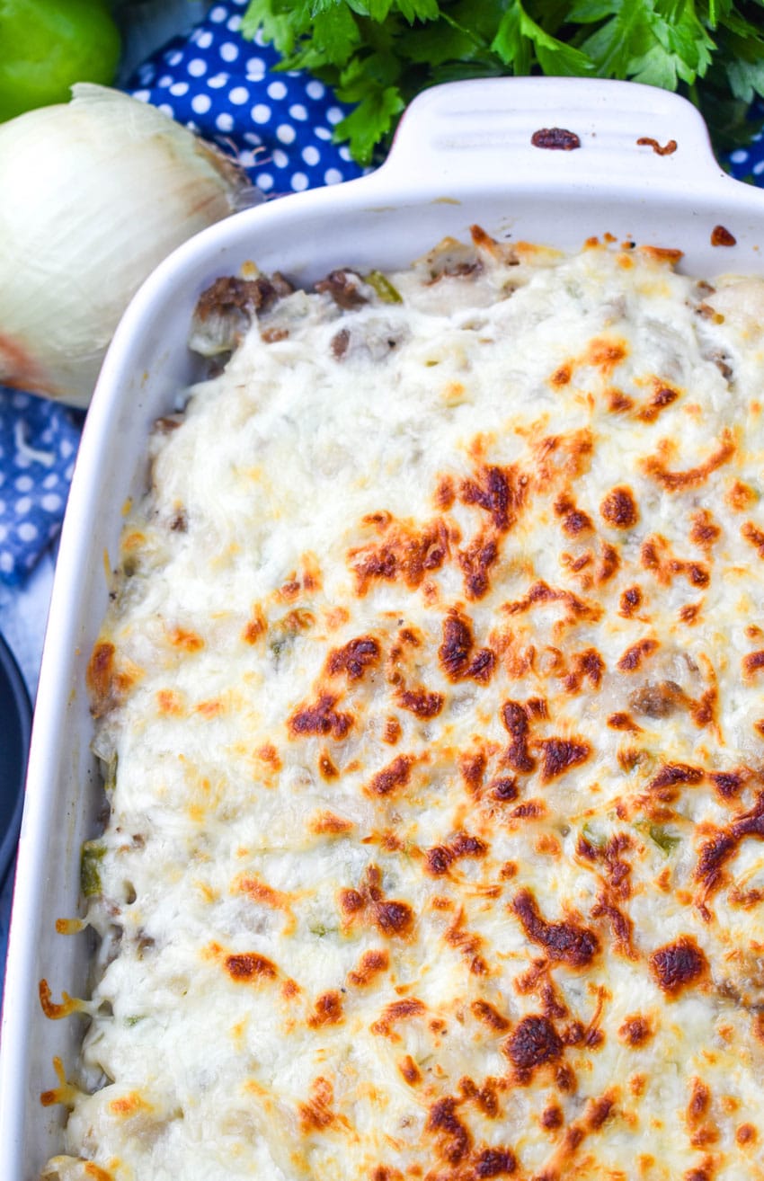 philly cheesesteak mac and cheese in a white baking dish