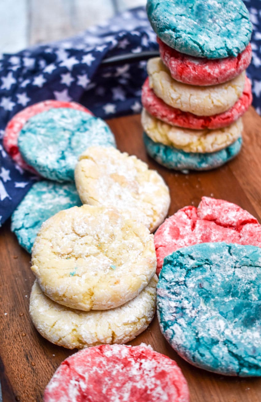 red white and blue crinkle cookies on a wooden cutting board