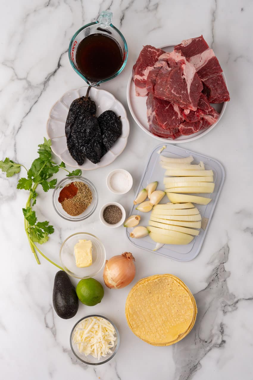 an overhead image showing the measured ingredients needed to make instant pot birria tacos