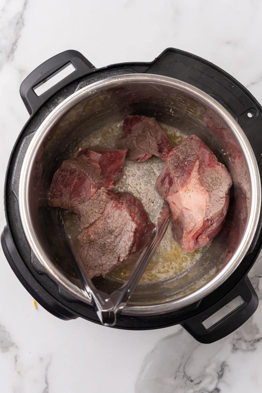 seasoned beef roast in the bowl of an instant pot