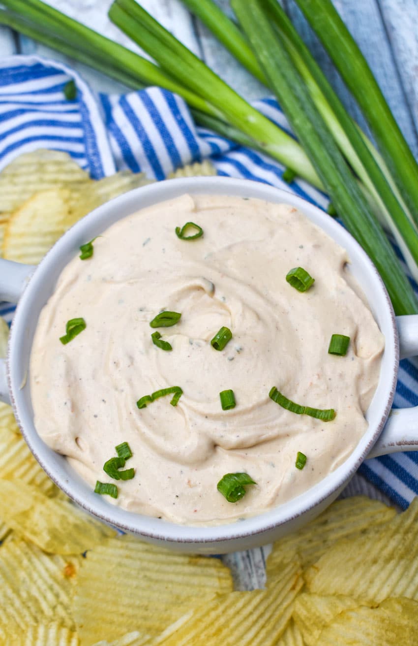 3 ingredient barbecue dip topped with sliced green onions in a small white bowl
