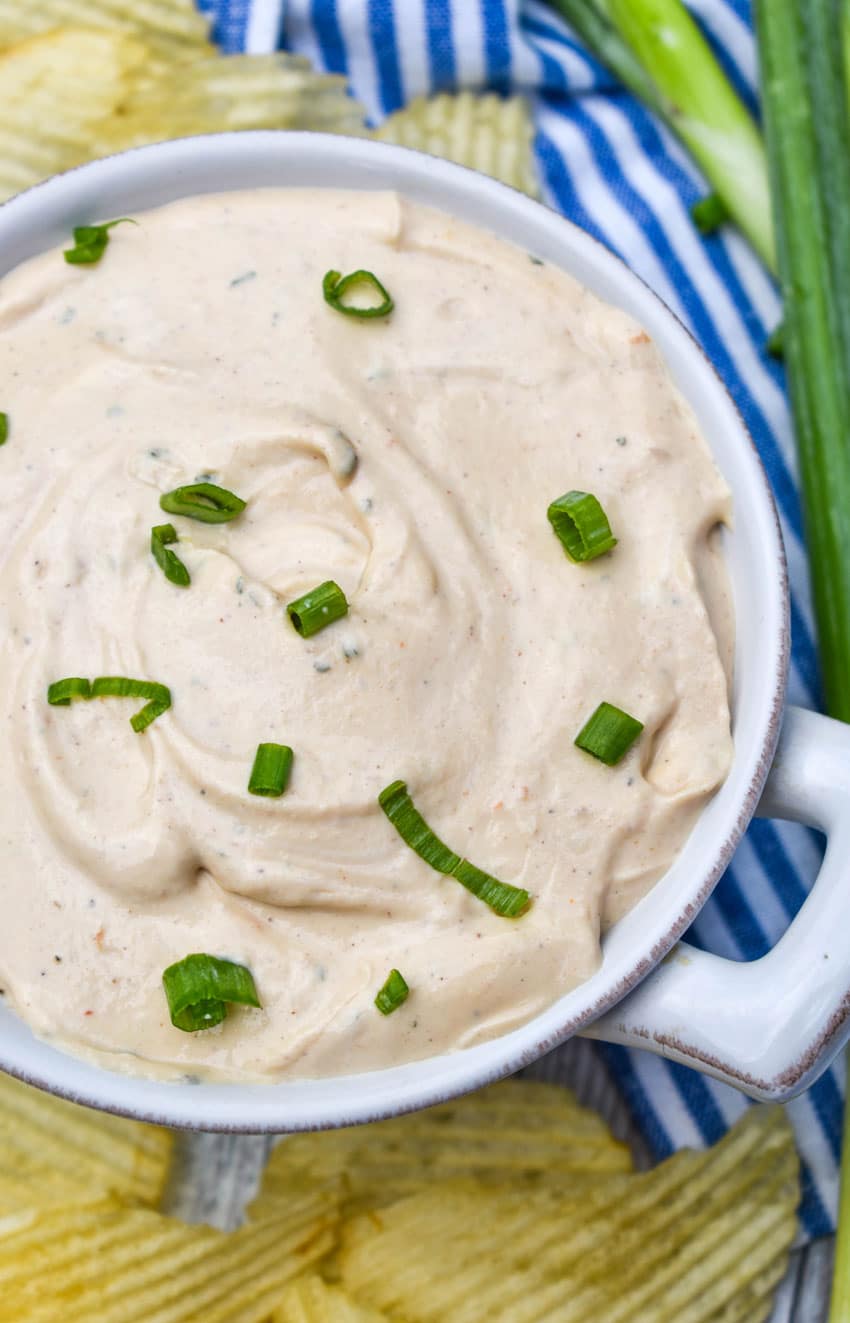 3 ingredient barbecue dip topped with sliced green onions in a small white bowl