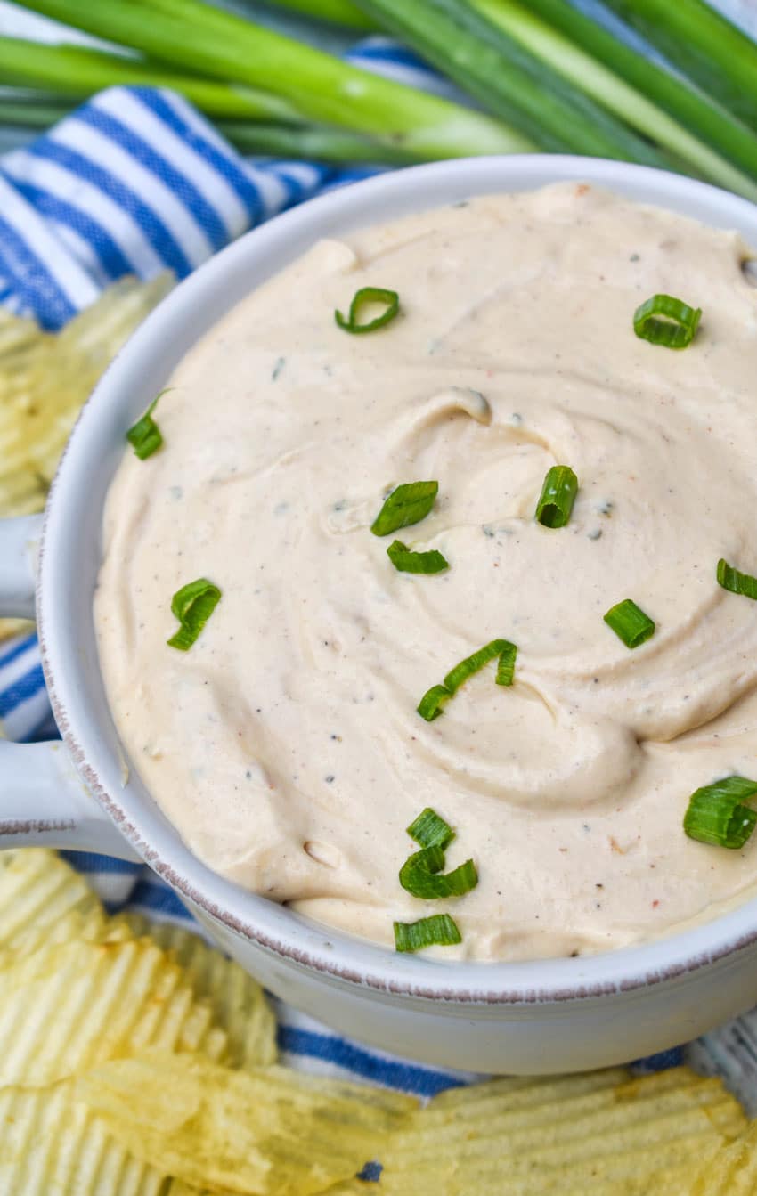3 ingredient barbecue dip topped with sliced green onions in a small white bowl