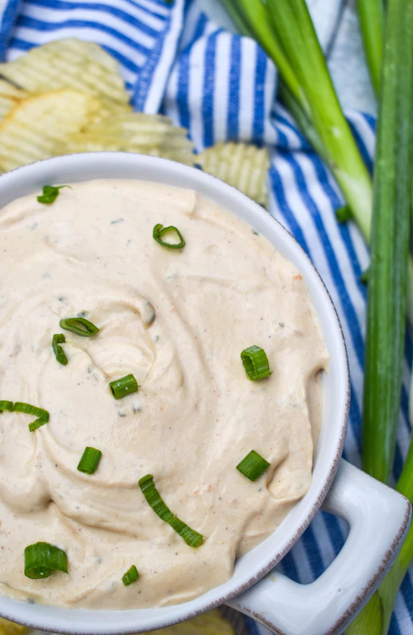 3 ingredient barbecue dip topped with sliced green onions in a small white bowl