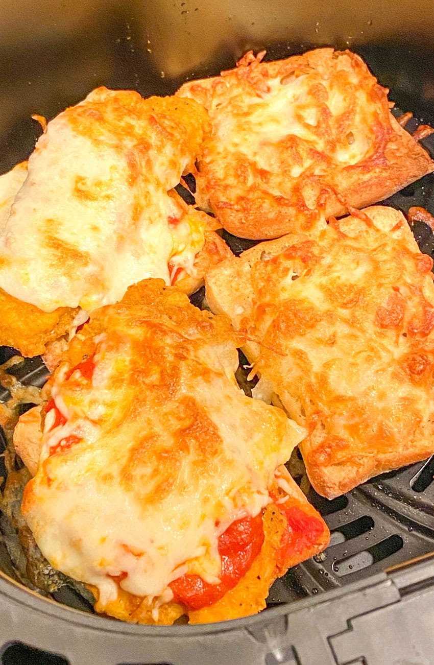 chicken parmesan sandwiches in the basket of an air fryer