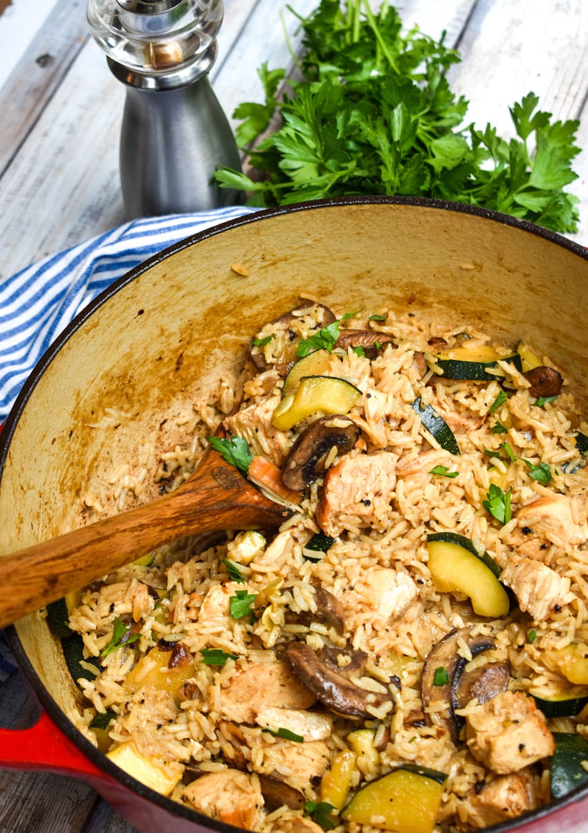 CHICKEN ZUCCHINI RICE SKILLET IN A LARGE RED DUTCH OVEN