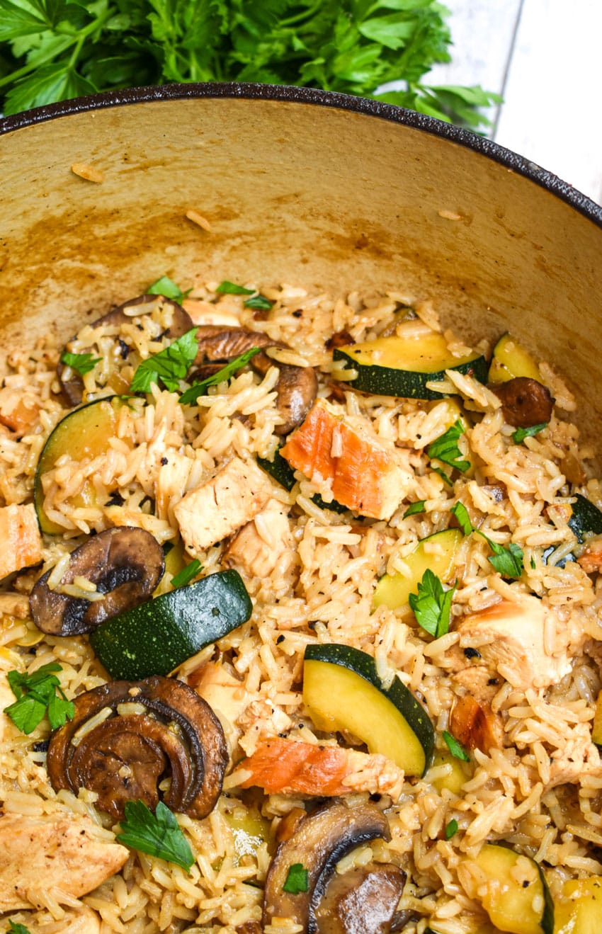 CHICKEN ZUCCHINI RICE SKILLET IN A LARGE RED DUTCH OVEN