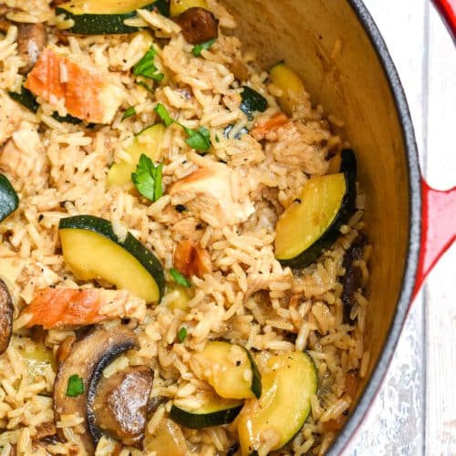 CHICKEN ZUCCHINI RICE SKILLET IN A LARGE RED DUTCH OVEN