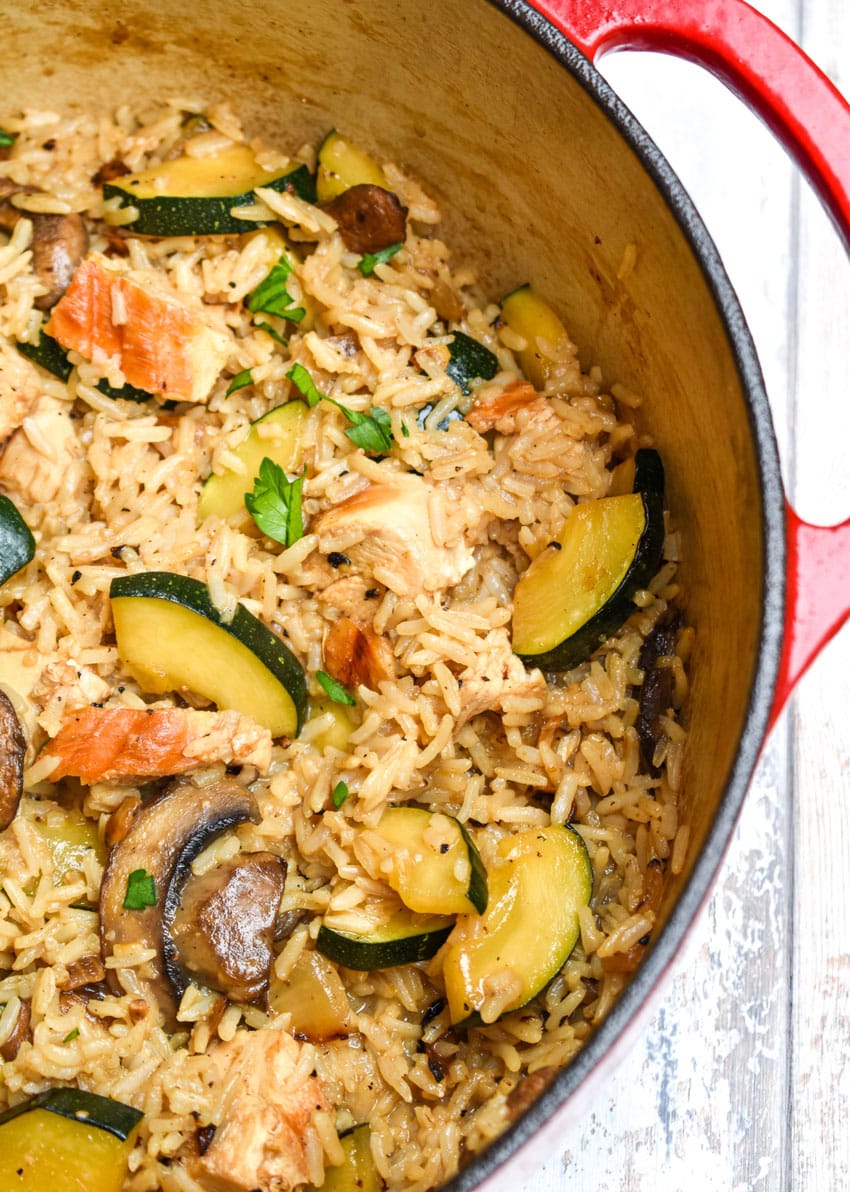 CHICKEN ZUCCHINI RICE SKILLET IN A LARGE RED DUTCH OVEN