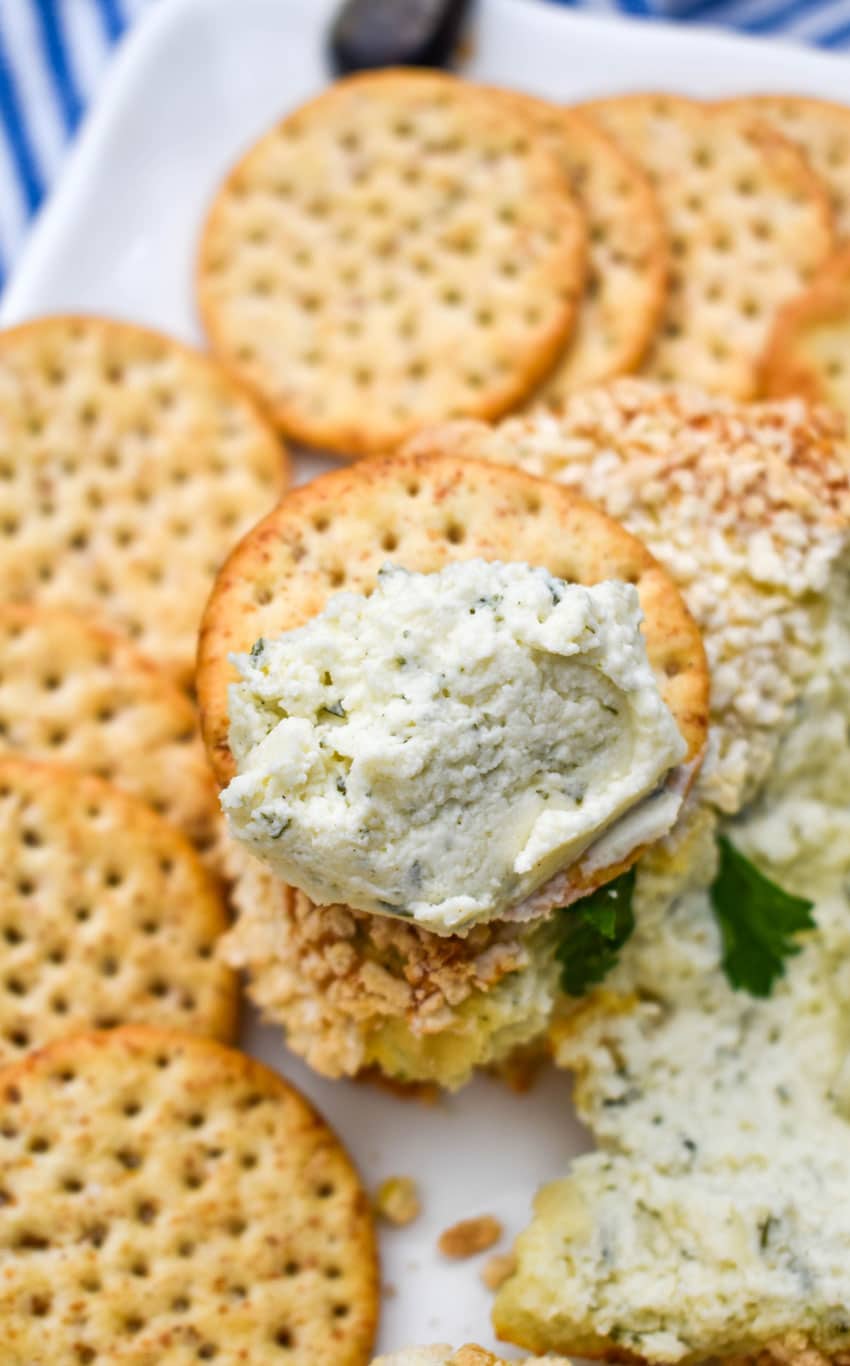 a wheat cracker topped with baked boursin cheese