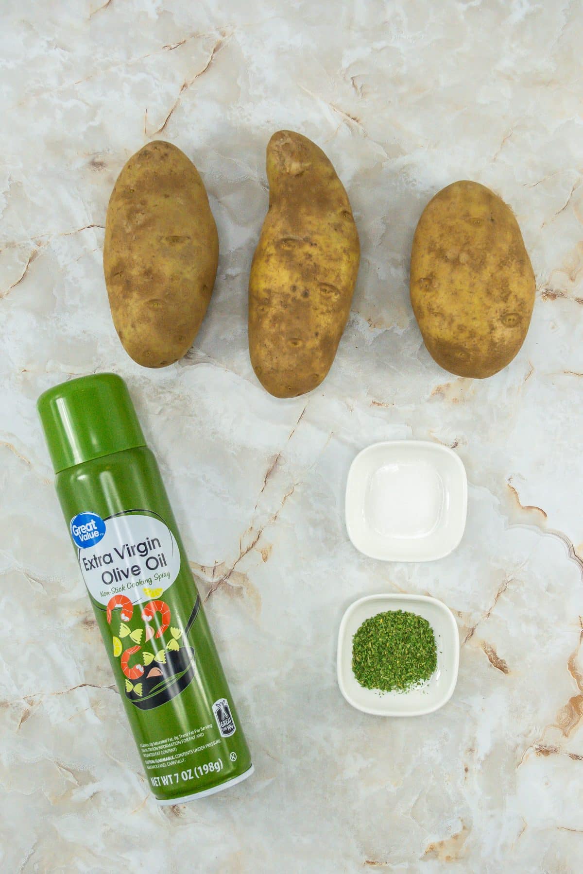 an overhead image showing the measured ingredients needed to make a batch of homemade potato chips in the air fryer