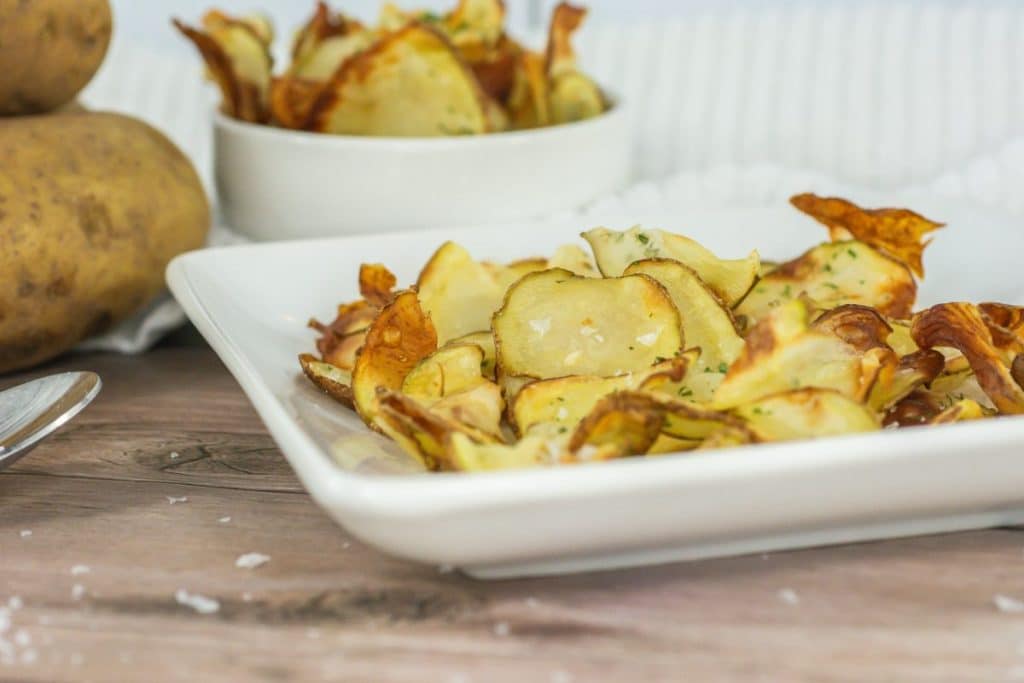 homemade potato chips on a small white plate