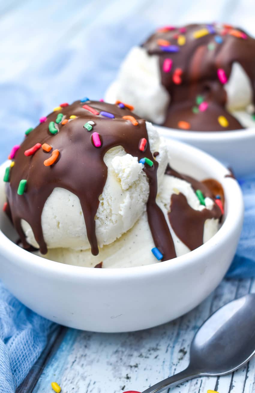 homemade magic shell recipe over scoops of vanilla ice cream in two small white bowls