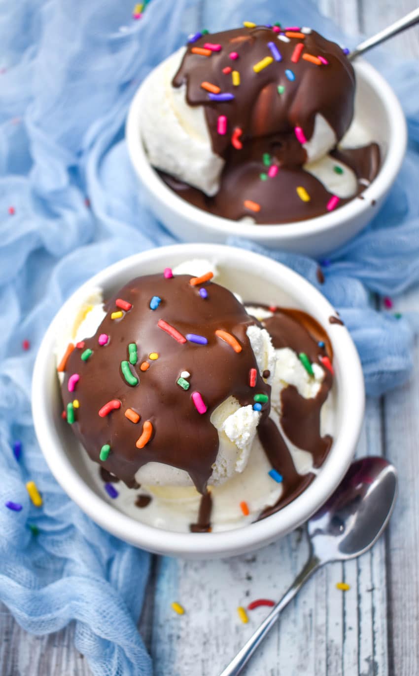 homemade magic shell recipe over scoops of vanilla ice cream in two small white bowls